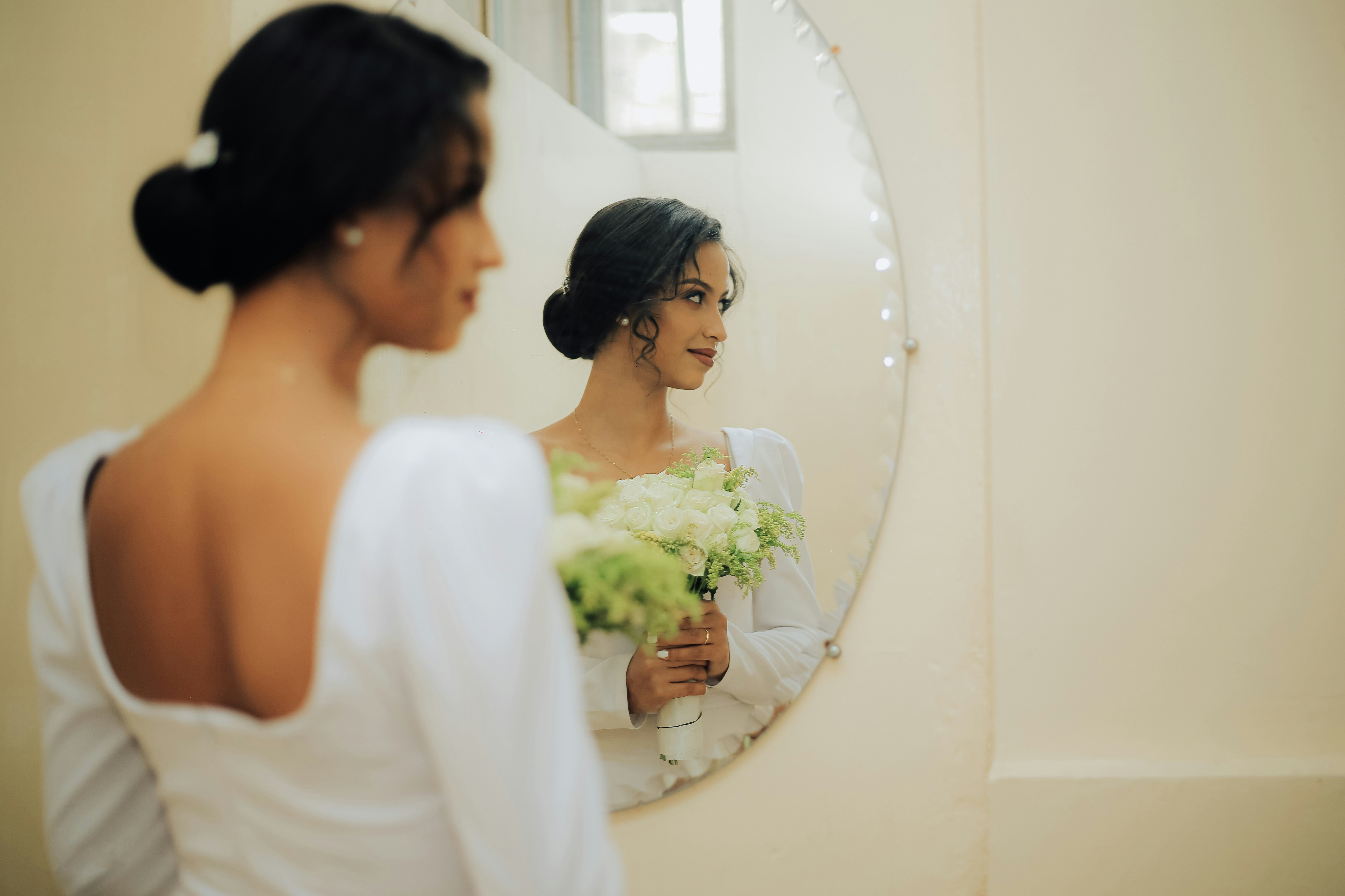 Woman standing in front of a mirror posing for the camera
